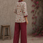 Soft white floral cotton top finished with maroon cuffs, pleated collar, and delicate feminine elegance.