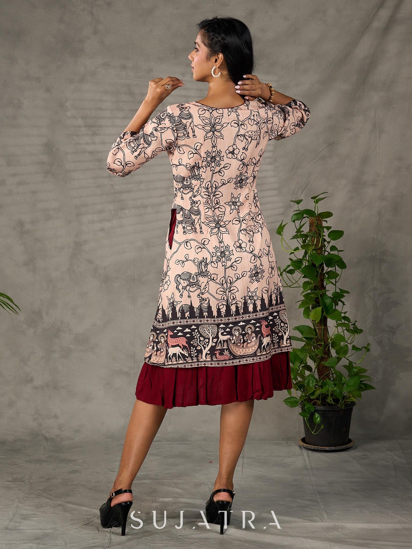 Beige traditional printed dress with rich maroon accents.