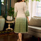 Serene ivory and sage green ombré overlap hakoba dress with olive button accents.