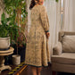 Artisanal beige Madhubani dress featuring intricate motifs, a contrasting green yoke, and refined accents.