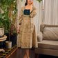Artisanal beige Madhubani dress featuring intricate motifs, a contrasting green yoke, and refined accents.