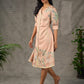 Peach Kalamkari-inspired shirt dress with soft beige accents.