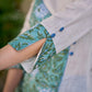 Breezy White Cotton Kurta with Green Floral Hand Block Print Asymmetric Panel and Cold Shoulder Accent