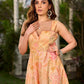 Effortless sunshine yellow floral dress designed with a delicate neckline, gathered straps, and a breezy, flowy form.