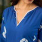 Refreshing cobalt blue shibori tie-dye dress with ivory accents and delicate lace-trimmed neckline.