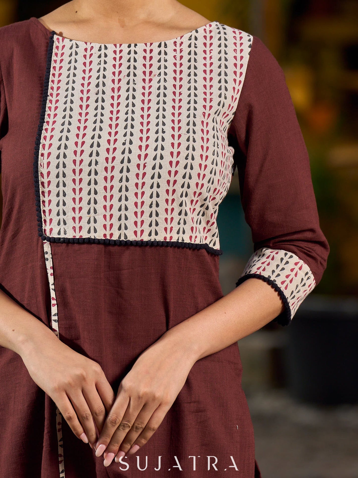 Brown cotton straight kurta with white Ajrakh patch and black accents.
