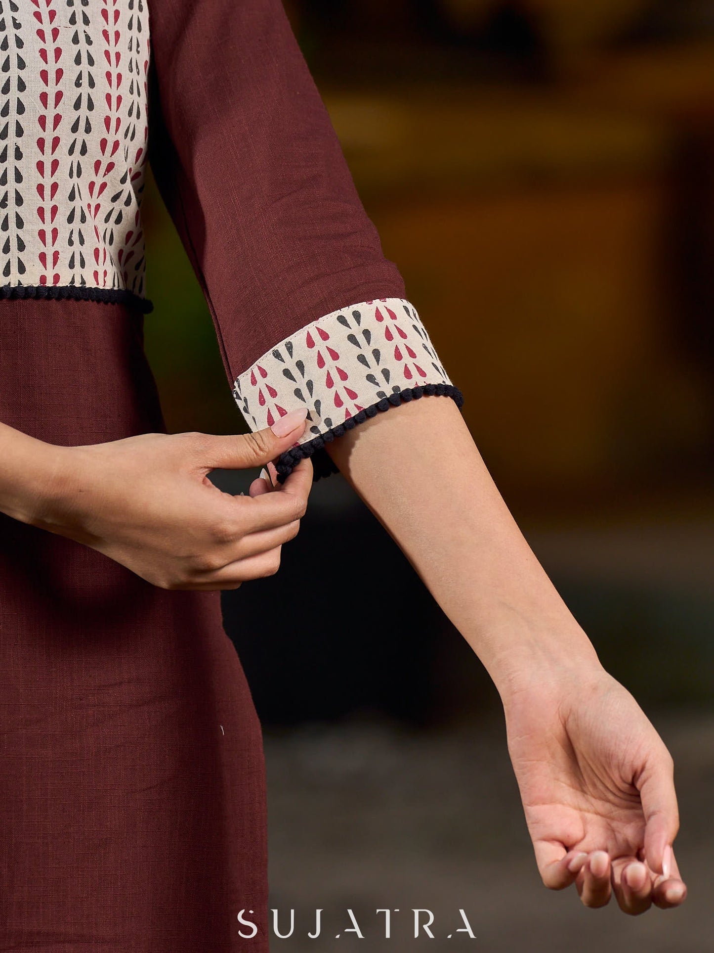 Brown cotton straight kurta with white Ajrakh patch and black accents.