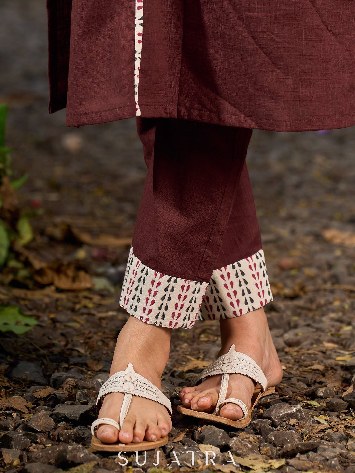 Brown cotton straight kurta with white Ajrakh patch and black accents.