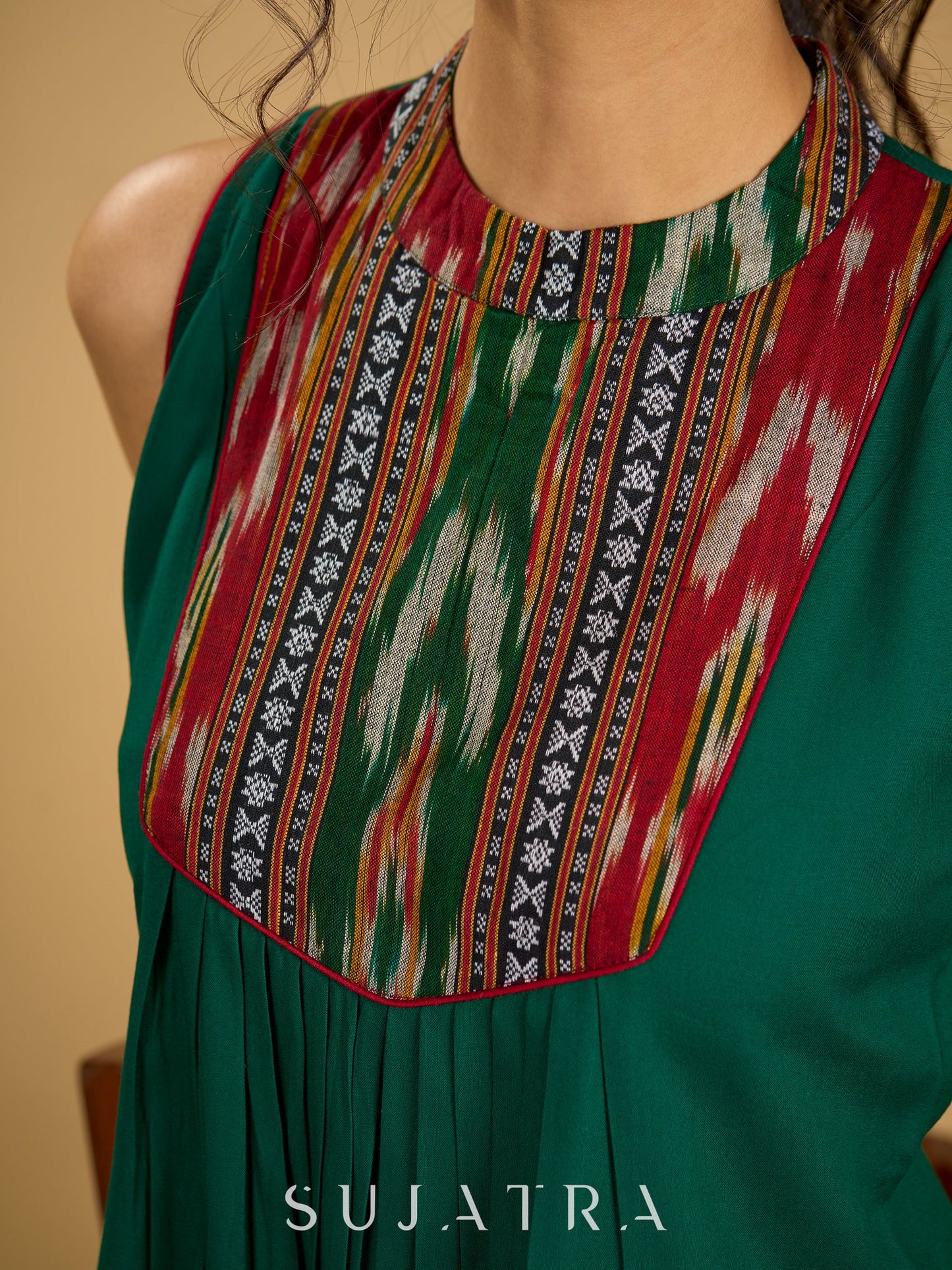 Elegant rayon green sleeveless top with ikat accents.