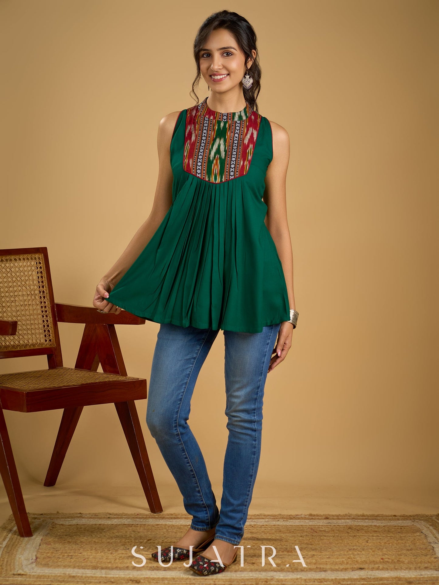 Elegant rayon green sleeveless top with ikat accents.