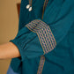 Elegant cotton teal top featuring graceful and unique detailing.