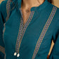 Elegant cotton teal top featuring graceful and unique detailing.