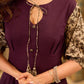Playful purple cotton dress showcasing floral puff sleeves and box pleats released from the dart for soft volume and flow
