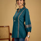 Elegant cotton teal top featuring graceful and unique detailing.