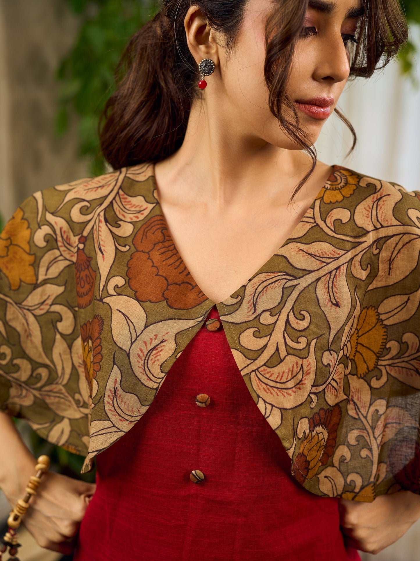 Elegant maroon dress featuring an attached artisan Kalamkari shoulder cape.