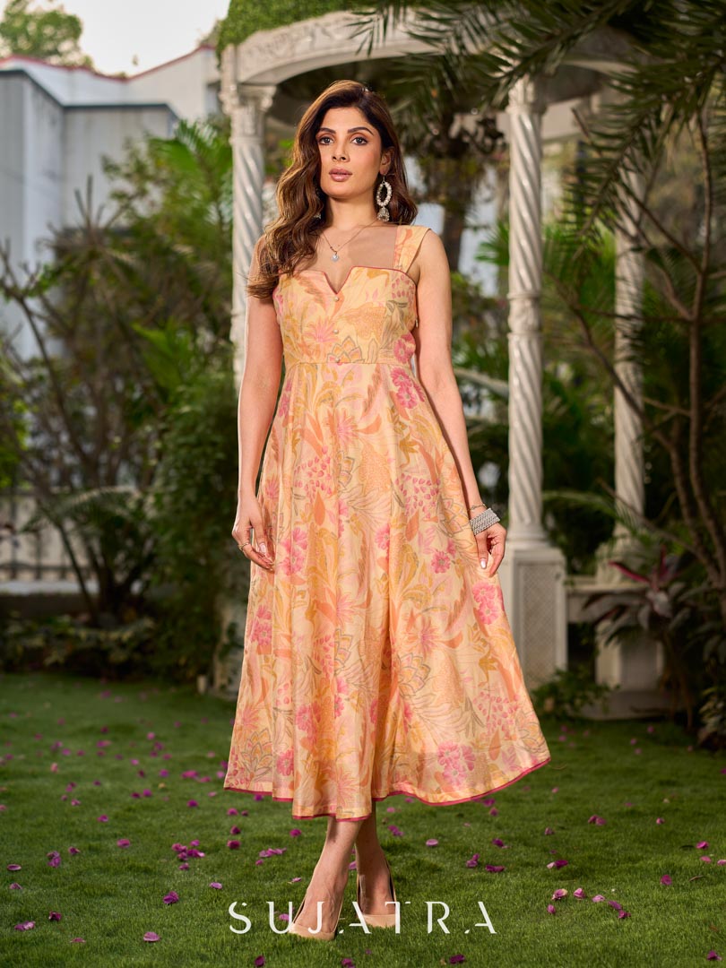 Effortless sunshine yellow floral dress designed with a delicate neckline, gathered straps, and a breezy, flowy form.
