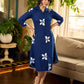 Navy blue apple-cut shirt dress with white floral hand block motifs, conceptually placed and finished with clean white edging and red accents for a refined, contemporary look.