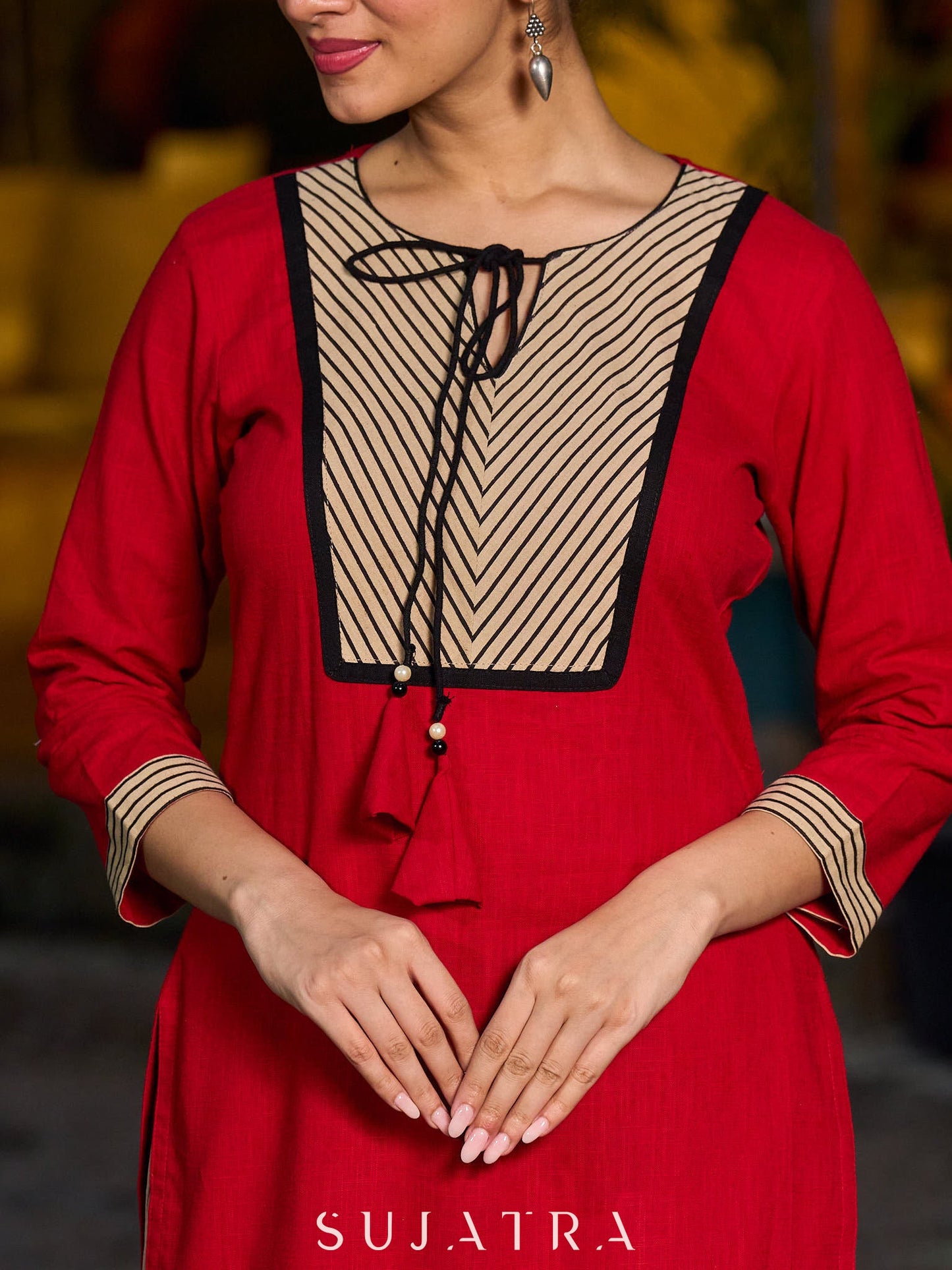 Elegant red kurta featuring a V-shaped striped neck panel