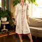 Off-white dandelion pleated shirt dress featuring dandelion placement block prints, checkered block-printed collar and cuffs, and red accents for a fresh, artisanal everyday look.