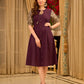 Playful purple cotton dress showcasing floral puff sleeves and box pleats released from the dart for soft volume and flow