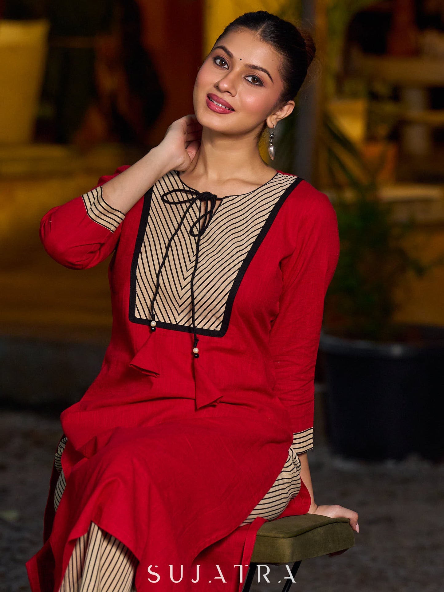 Elegant red kurta featuring a V-shaped striped neck panel