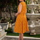 Statement mercerised mustard Ikat dress elevated with drop-shoulder styling, pleated neckline and sleeves detailing featuring soft box pleats for ease and movement