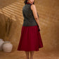 Sharp dark teal and maroon checkered sleeveless jacket with a distinctive notch collar and princess-cut tailoring, offering a structured silhouette ideal for elevated corporate styling.