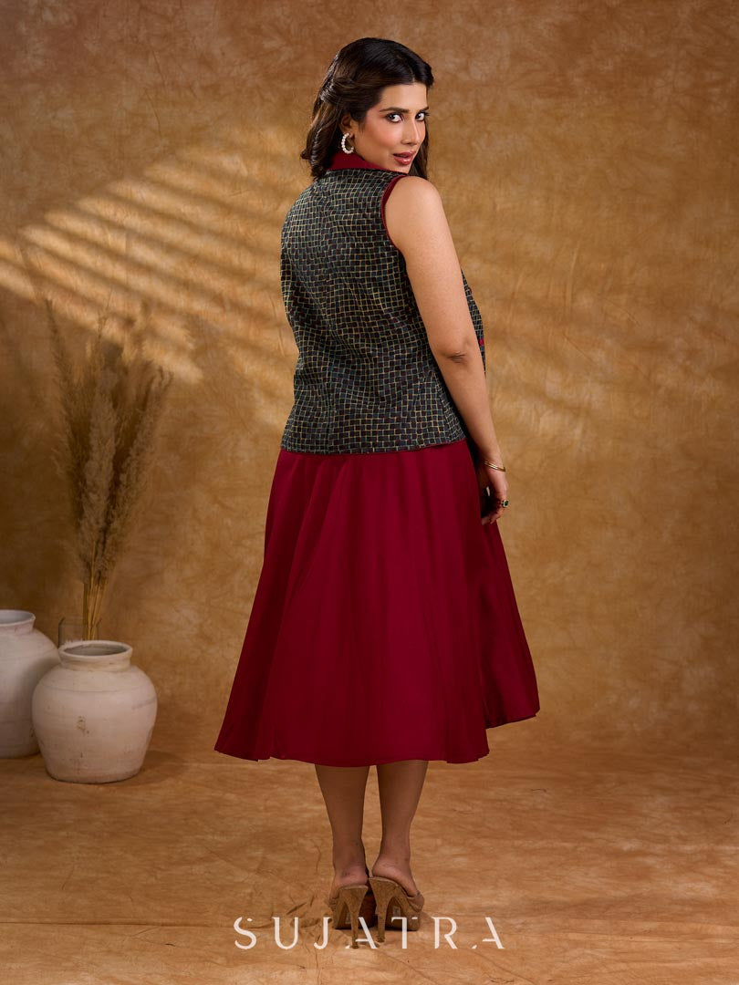 Sharp dark teal and maroon checkered sleeveless jacket with a distinctive notch collar and princess-cut tailoring, offering a structured silhouette ideal for elevated corporate styling.