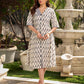 Modern white and grey Ikat shirt dress elevated with an asymmetrical checkered Ikat collar and contrast black accents.
