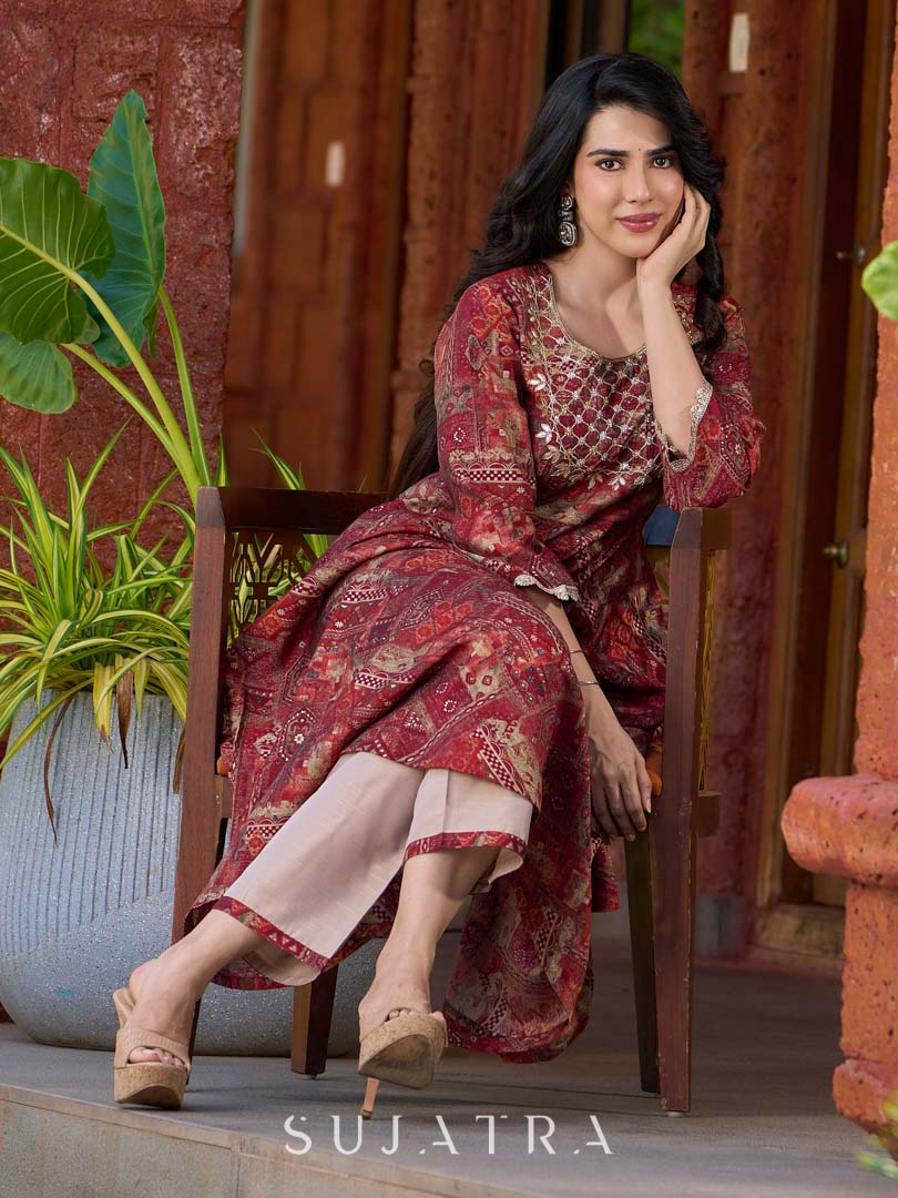 Exquisite deep maroon printed kurta with a graceful bias silhouette, intricate handwork on the yoke, and scalloped sleeve detailing.