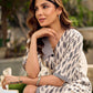 Modern white and grey Ikat shirt dress elevated with an asymmetrical checkered Ikat collar and contrast black accents.