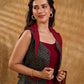 Sharp dark teal and maroon checkered sleeveless jacket with a distinctive notch collar and princess-cut tailoring, offering a structured silhouette ideal for elevated corporate styling.