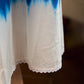 Refreshing cobalt blue shibori tie-dye dress with ivory accents and delicate lace-trimmed neckline.