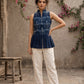 Contemporary indigo top with delicate dragonfly motifs, high folded collar, and graceful pleated hemline.