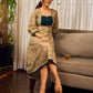 Artisanal beige Madhubani dress featuring intricate motifs, a contrasting green yoke, and refined accents.