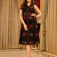Statement black sleeveless shirt dress showcasing elephant-inspired prints and polka dots, highlighted with maroon accents.