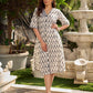 Modern white and grey Ikat shirt dress elevated with an asymmetrical checkered Ikat collar and contrast black accents.
