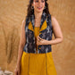 Tailored black Kantha jacket featuring fish motifs, a mustard pintuck patch, and a flipped collar, offering a structured silhouette with refined detail and distinctive, contemporary character.