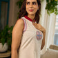 Off-white dress featuring intricate Madhubani artwork and a maroon Mandarin collar.