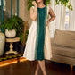 Bottle green and off-white hand block printed sleeveless dress with a block printed geometric panel, pearl embellishments, and refined accents for a contemporary artisanal look.