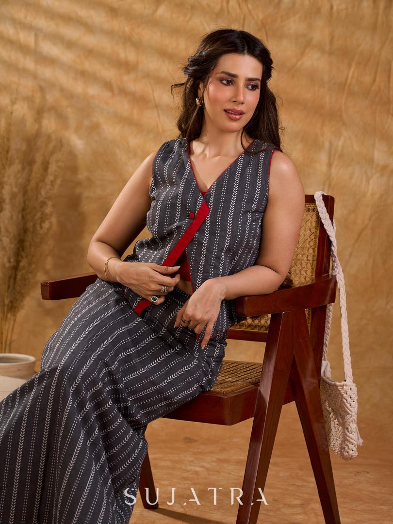 Textured grey Jamdani sleeveless waistcoat with bold red accents and an asymmetrical opening, creating a sharp, modern silhouette with distinctive, fashion-forward appeal.