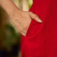 Vibrant red sleeveless dress with a bold off-white floral hand block print at the hem and clean off-white edging for a striking, handcrafted-inspired finish.