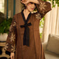 Brown block print dress with floral block printed flared sleeves, black tie-up neckline, and contrast black accents for an effortless, elegant everyday look.