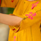 Mustard block printed pintuck dress with hand block red and pink vine floral motifs, accented with red and olive details for a rich, elegant look.
