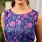 Enchanting purple panel dress featuring vibrant magenta floral prints, a sleeveless silhouette, and a graceful fit-and-flare design for timeless elegance.
