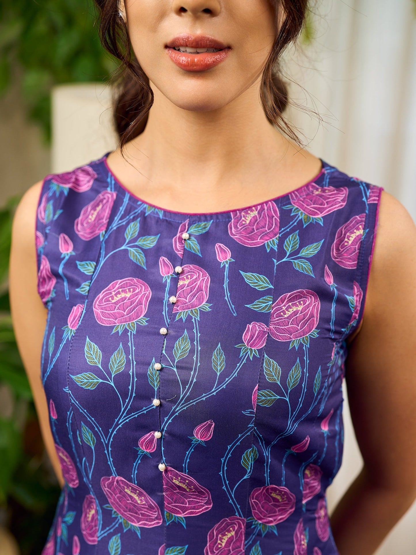 Enchanting purple panel dress featuring vibrant magenta floral prints, a sleeveless silhouette, and a graceful fit-and-flare design for timeless elegance.