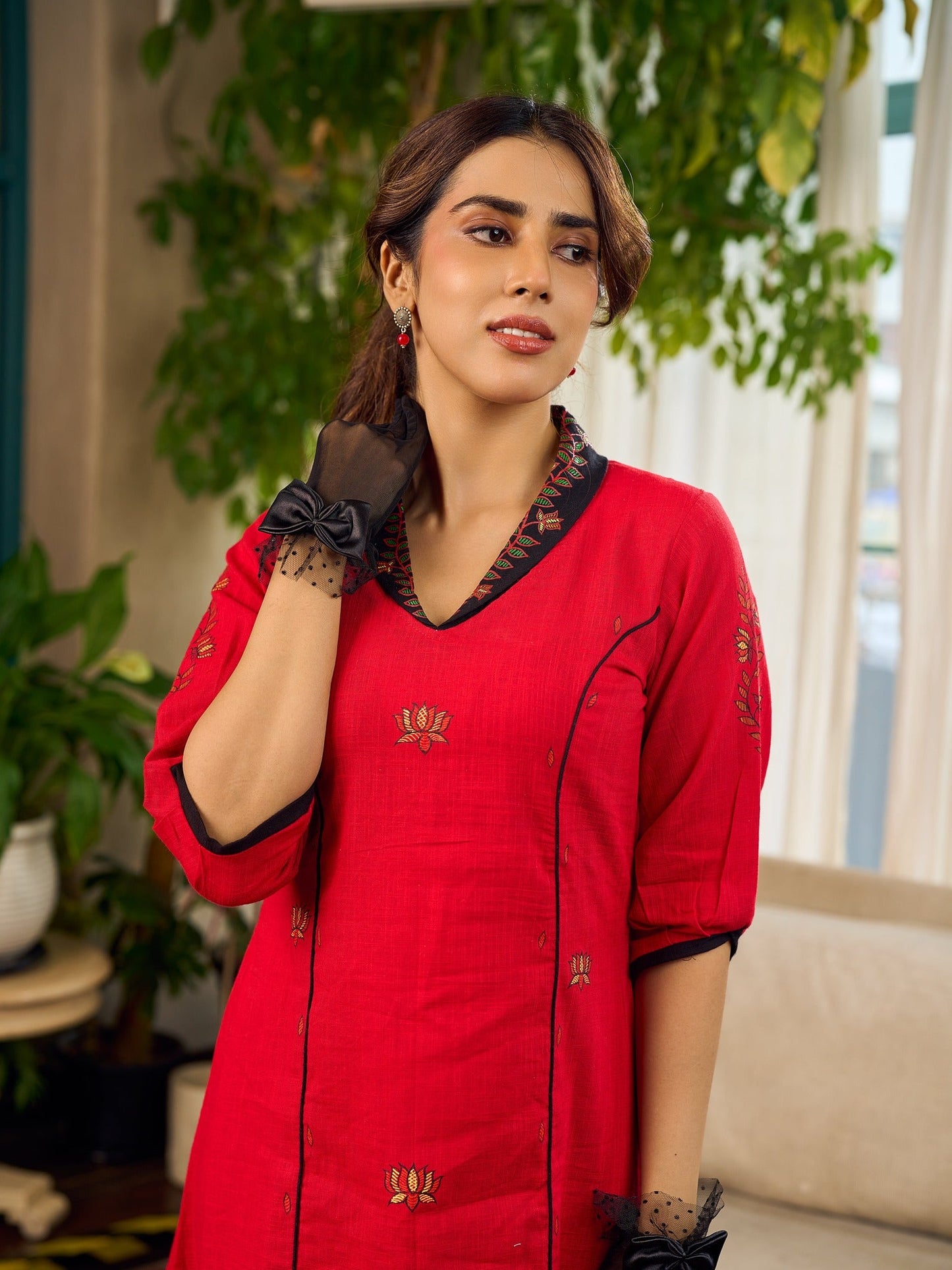 Elegant red dress featuring delicate, hand-painted Madhubani lotus motif detailing.