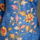 Indigo Kalamkari printed dress with vibrant red and mustard accents.