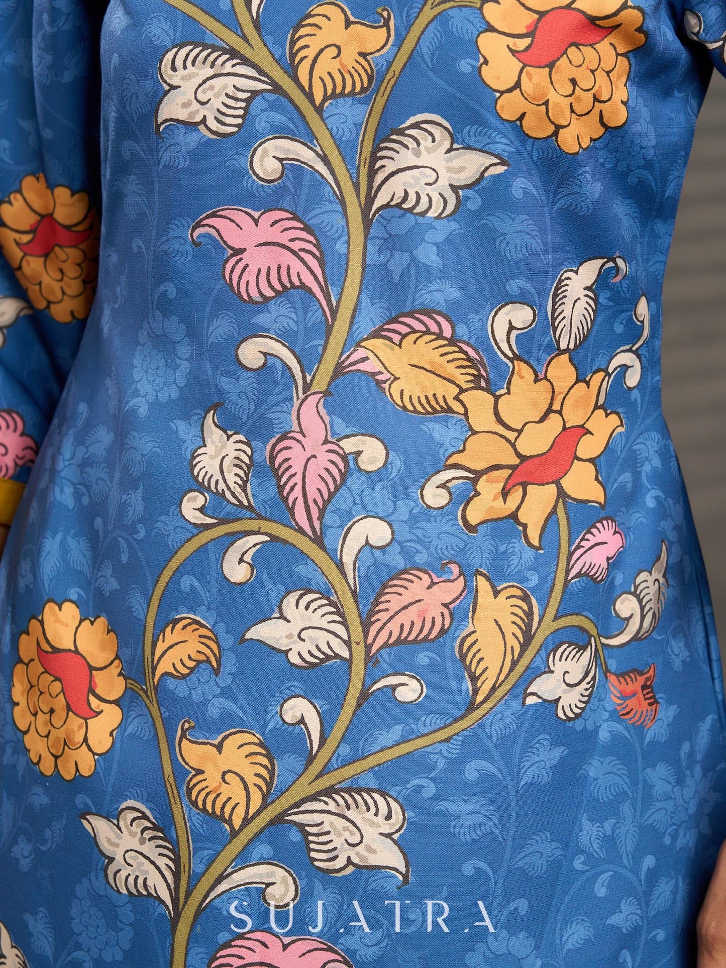 Indigo Kalamkari printed dress with vibrant red and mustard accents.
