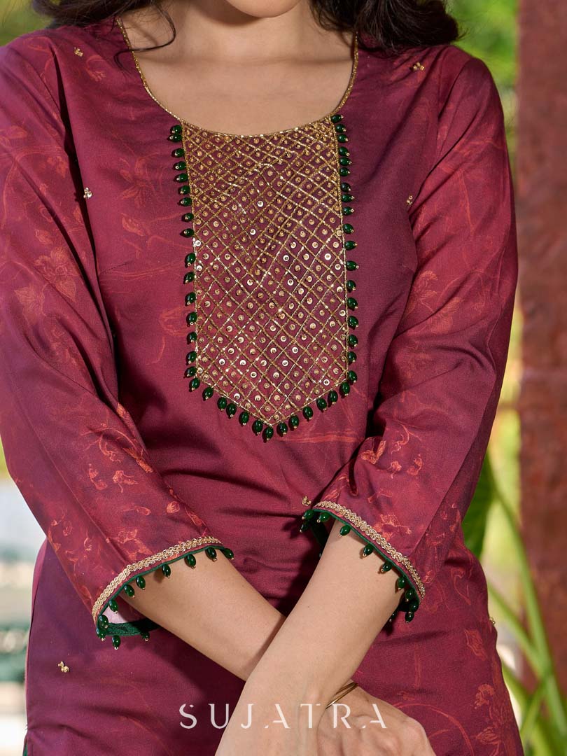 Exquisite deep burgundy printed kurta with intricate neck panel embroidery, delicate green beads, and refined green highlights.